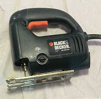 Left side view of Black & Decker jigsaw showing branding and blade area