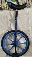 Full front view of blue unicycle