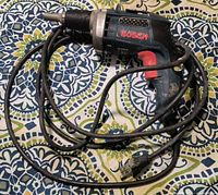 Side view of Bosch drywall screw gun with coiled cord