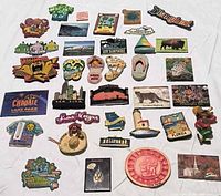 Overall group of 34 destination magnets displayed on white background