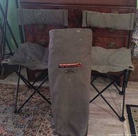 Two canvas folding chairs and carry bag front view, logos visible