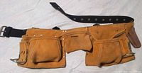 Front view showing Husky logo, pouches, hammer holders, belt