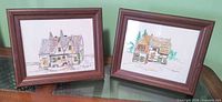 Both framed watercolor paintings side by side showing frames and artwork