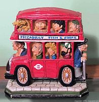 Front left view of red double-decker bus figurine on base