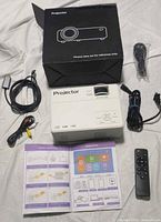 Top view of projector with all accessories and box