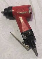 Full view of red Rodac pneumatic impact wrench showing air fitting and trigger
