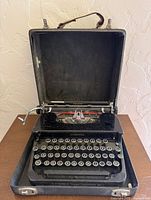 Typewriter seated in open case, full view