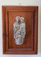 Front view showing entire framed pewter Holy Family relief on wood plaque