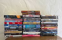 Overall view of three tall stacks of DVD cases on table