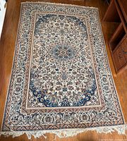 Full view of Persian Kashan rug on hardwood floor