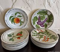 Stacks of Williams-Sonoma Orchard Suite plates, assorted fruit and vegetable designs