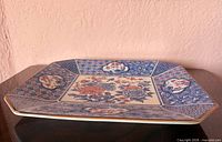Oblique view of entire porcelain platter showing octagonal shape and border design