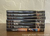Seven James Bond DVDs stacked, spines visible