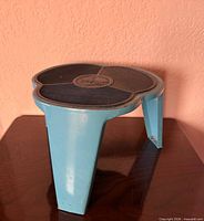 Full view of blue metal Kik-Step step stool on wooden surface