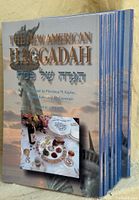 Front view showing stack of eight New American Haggadah books