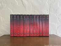 Front view showing all twelve V Collector's Edition VHS tapes upright