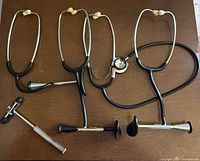 Overview of three stethoscopes and reflex hammer