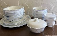Full set showing stacks of soup plates, dessert bowls, dinner plates, mug and covered sugar bowl