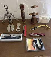 Group shot of all eleven openers and acrylic box on table