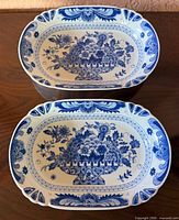 two matching blue floral basket oval dishes