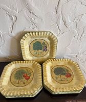 Stack and displayed view of seven square fluted plates