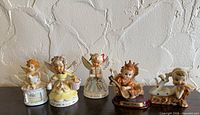 Front view of all five cherub figurines