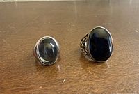 Front view showing faces of both rings and black cabochon stones