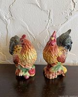 Front view of both rooster shakers showing colour and design