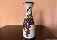 Front view of vase showing grape cluster design
