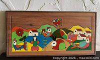 Full view of painted wood wall panel showing complete folk art scene
