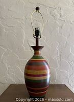 Full view of lamp showing striped body and harp