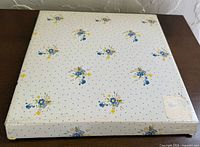 Cardboard presentation box with blue and yellow floral pattern