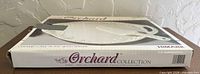 Box front showing Orchard Collection ceramic cake plate with server, Himark branding