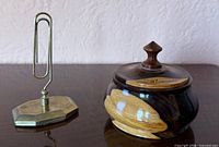 Paperclip stand and trinket box side by side on table