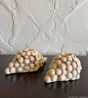 Two ceramic grape cluster candle holders, top view