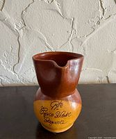 Front view showing two-tone glaze and inscription