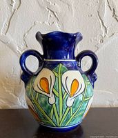 Front view showing calla lily design and double handles