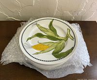 Stack of plates with top corn design