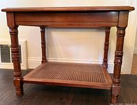 Angled view showing wood frame, turned legs, and cane shelf