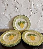 Stack of six lemon motif plates, one displayed upright