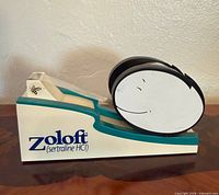 Left side view showing Zoloft branding and smiling face reel