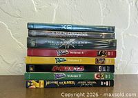 Stack of seven X-Men and Wolverine DVDs