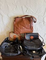 Overall view of five bags arranged on surface