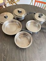 Top view of all cookware pieces and lids on table