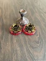Overall view showing one sterling body and two red lucite bases with brass flowers