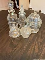 Group shot showing all five clear glass jars with lids