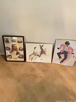 All three framed prints against wall