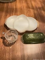 All three items grouped: green butter dish lid/base, white divided bowl, clear cup