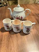 Full view of teapot and three cups