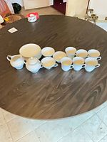 Entire 17-piece porcelain tea service laid out on table